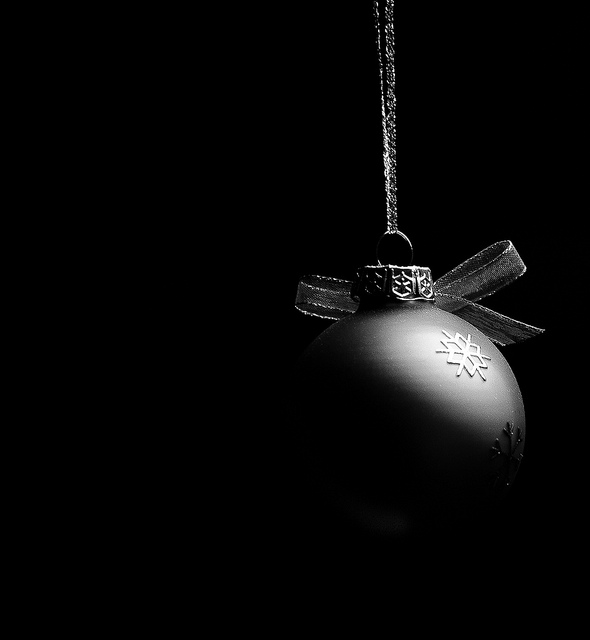 Low key photo of a hanging Christmas bauble
