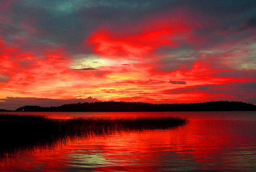 Burning sky - deep red sunset reflected in lake