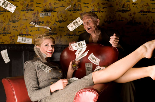 Stock Photo of Woman Throwing Money in Air with Senior Man