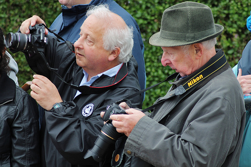 Photographers using cameras with neck straps