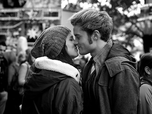 Candid portrait of a young couple kissing