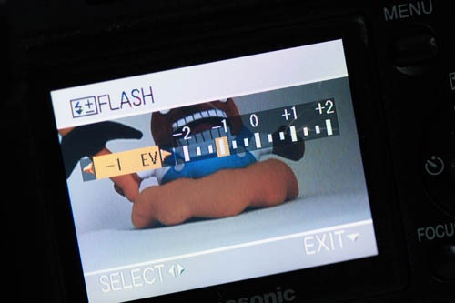 Setting the flash exposure compensation setting on a camera to reduce the flash power