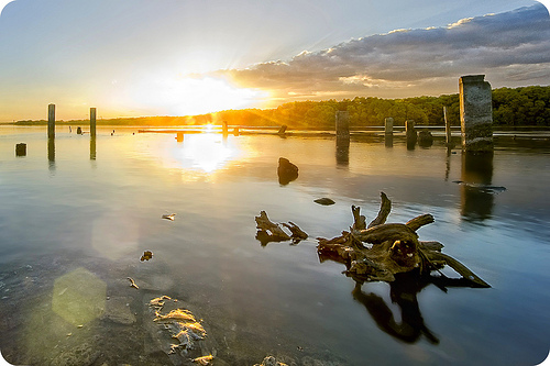 Landscape photo taken at sunset exhibiting iris flare