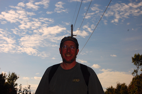 Portrait photo with pole in the background emerging from behind the subject's head