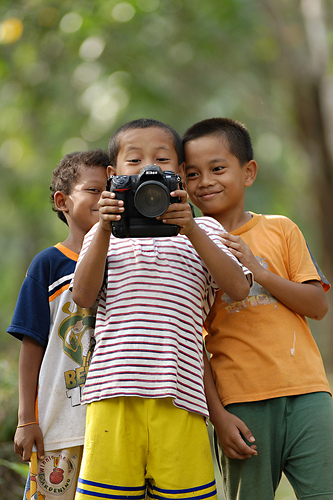 Portrait of children taken standing further back with a telephoto (zoomed in) focal length