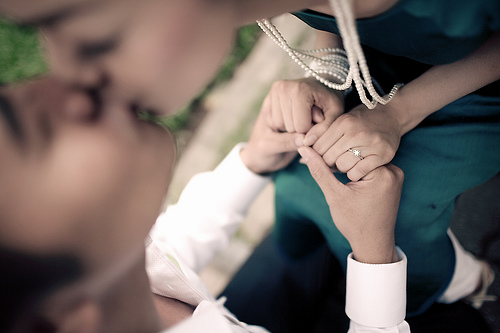 couple kissing, but with focus purposefully on their hands rather than their faces