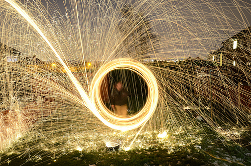 Burning steel wool sparks wheel outside