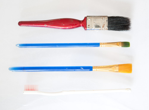Normal photo of paintbrushes and toothbrush