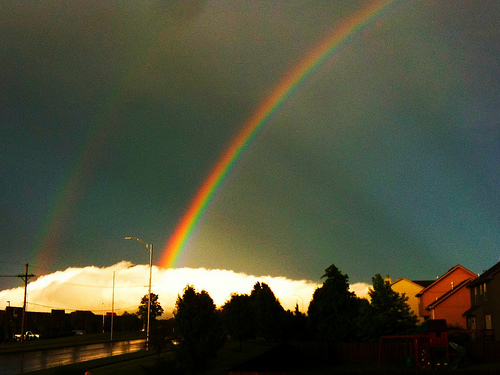 Rainbow against a dark sky, captured using a phone camera