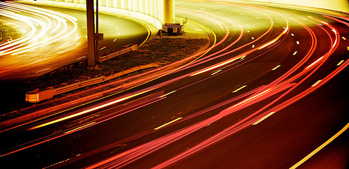 Light trails from cars entering and exiting a tunnel