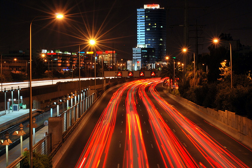 Stream of red light trails left by cars' tail lights