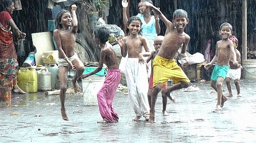 Happy children dancing in the rain