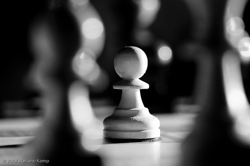 Still life photograph of a pawn on a chess board