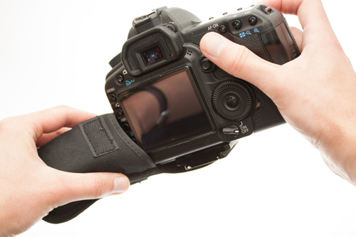 Trying to stuff a DSLR into a padded case designed for a compact camera