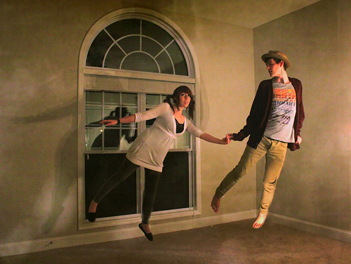Couple floating in an empty room