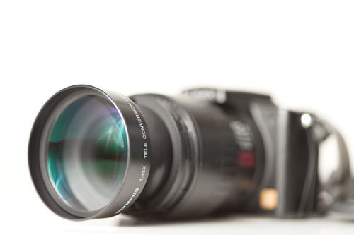 Add-on teleconverter lens attached to a superzoom camera