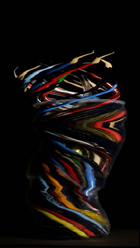 Slit-scan style photo of a pot of pens rotating on a turntable