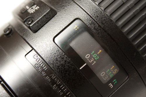 Macro lens showing magnification ratio markings on the lens focusing scale