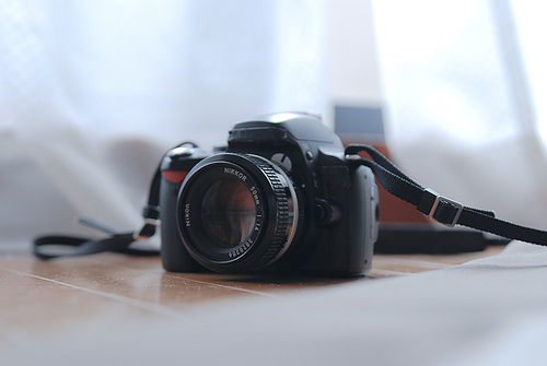 Camera with logos covered by black tape