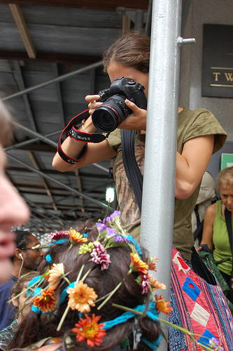 Photographer using a camera where the logos have been taped over