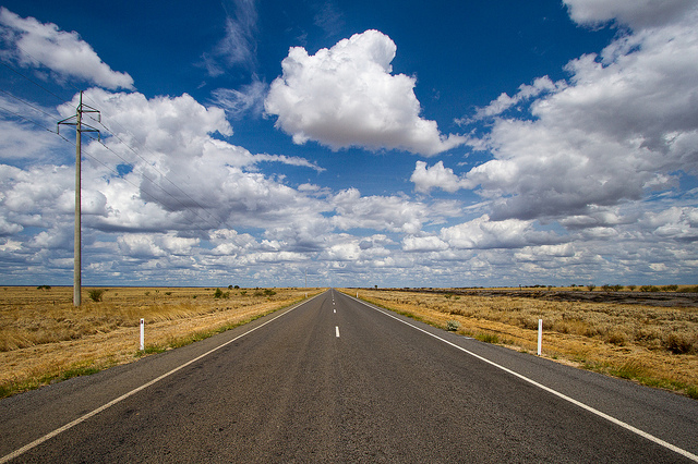 Landscape photo looking down a road, which creates converging lines towards the center of the image, giving a sense of depth