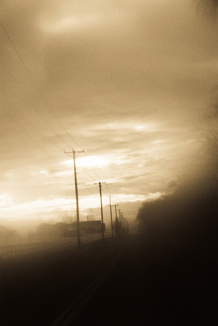 Landscape photo of telegraph poles along the edge of a road taken using vaseline on a UV filter to give a soft dreamy effect