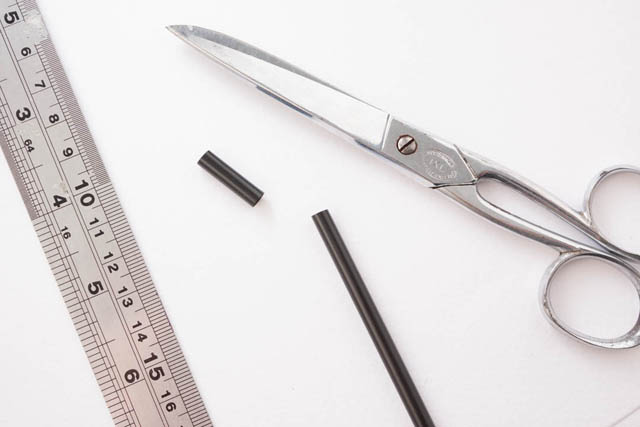 Metal ruler, Scissors, and a black straw with a 2 cm section cut off