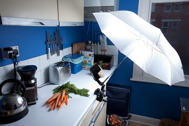 Carrots lighting setup - a speedlight flash and umbrella superclamped to the edge of a work surface in the kitchen