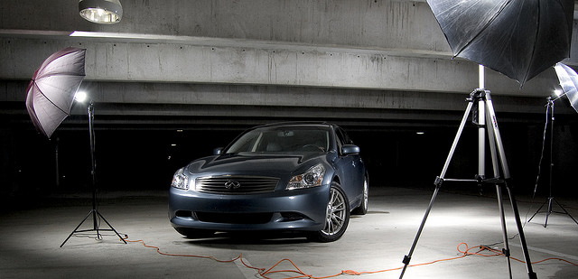 3 studio strobes for car shoot, with power cords for the lights trailing across the floor.