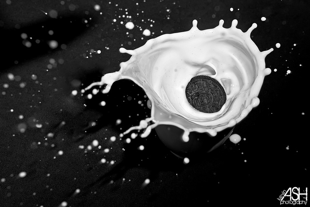 Oreo cookie splashing in milk, high speed photographed using flash with a relatively slow shutter speed (1/100s)