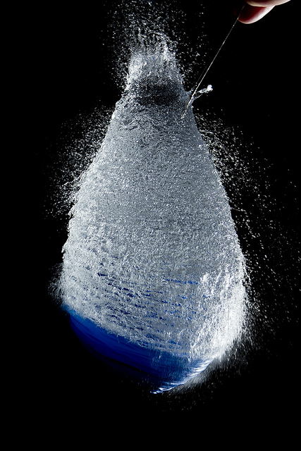 High Speed Photo of a water balloon bursting, flash triggered by an infrared beam being broken