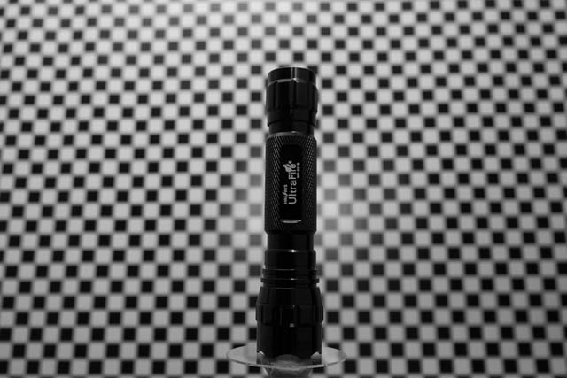 Photo of a torch taken with a wide angle lens. In the background are squares to show that a relatively large portion of the background is captured compared to a longer focal length.