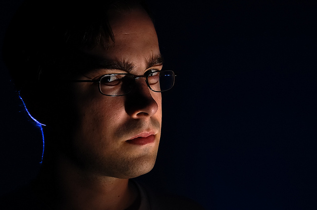 Dramatically lit portrait using manual off-camera flash.