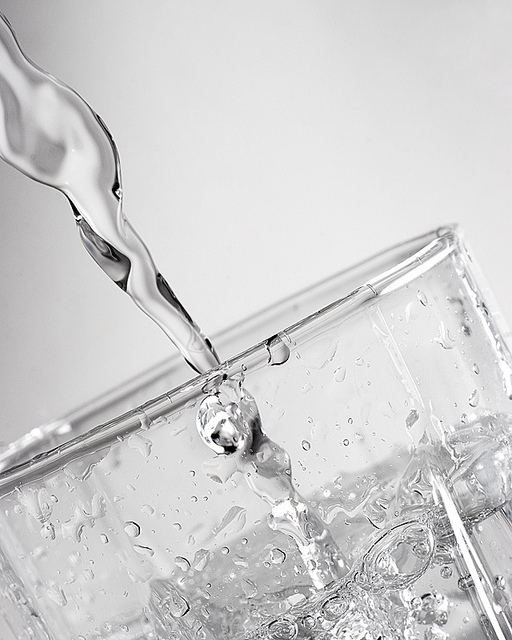 Photo of water being poured into a glass taken with off camera flash using manual power setting