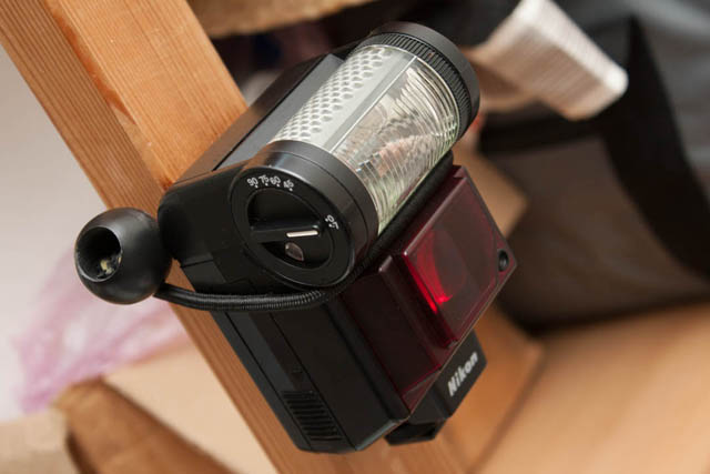 Speedlight with non-rotating head bungeed to support - flash controls are inaccessible.