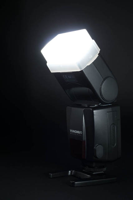 Speedlight flash on stand, with diffusion dome attached