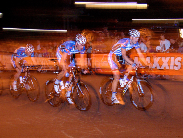 Men's Cycle race, photographed using a slow shutter speed and first curtain flash. The riders almost appear to be going backwards as their blurred outlines stretch in front of them.